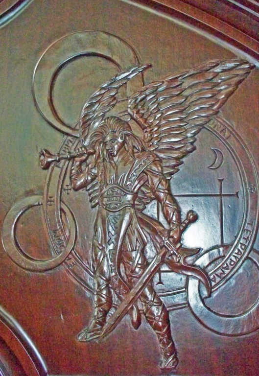 detailed carving of medieval warrior angel on a mahogany entrance door